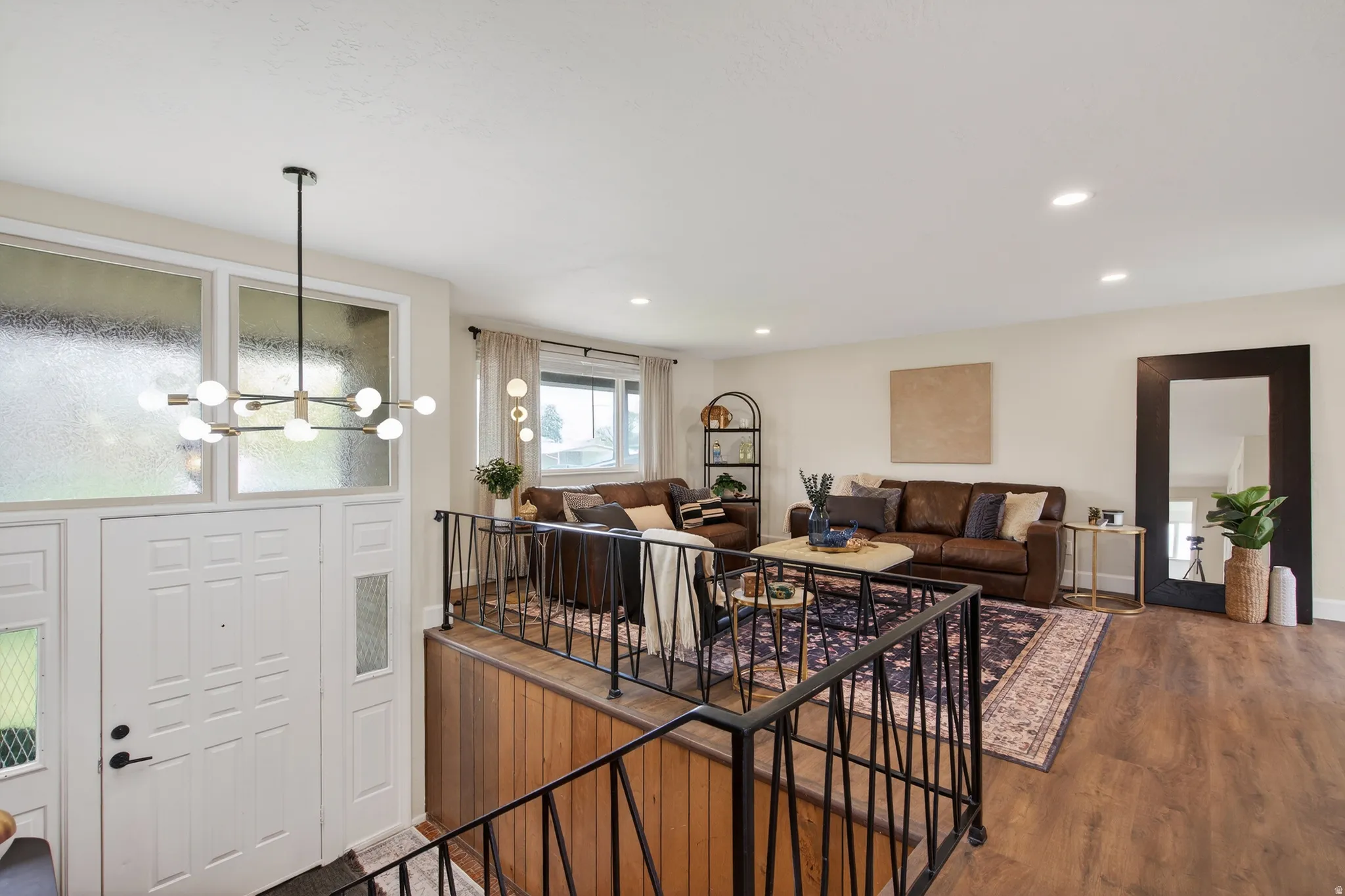Living area with LVP floors and a chandelier