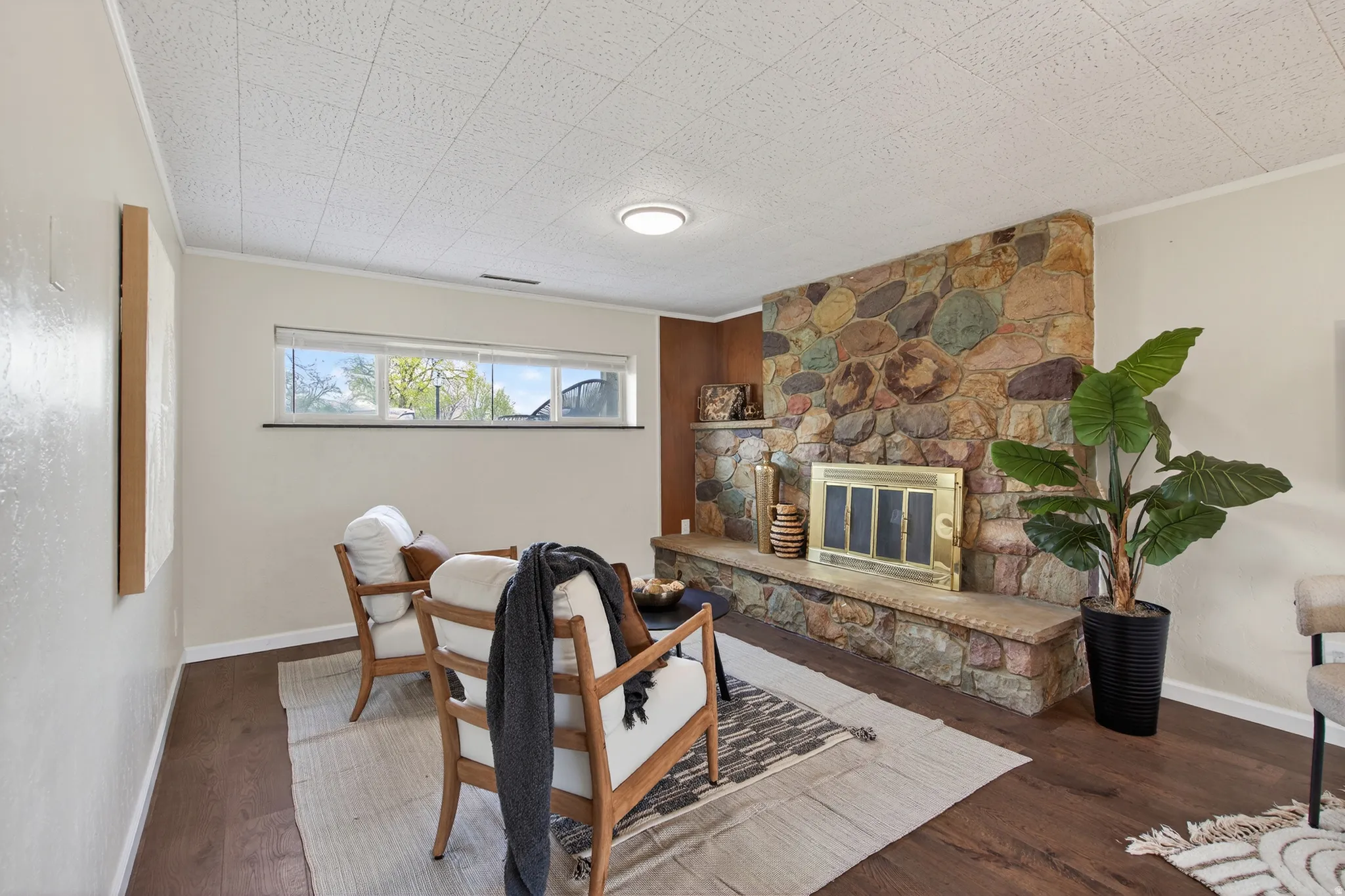 Living area with a stone fireplace, and LVP floors
