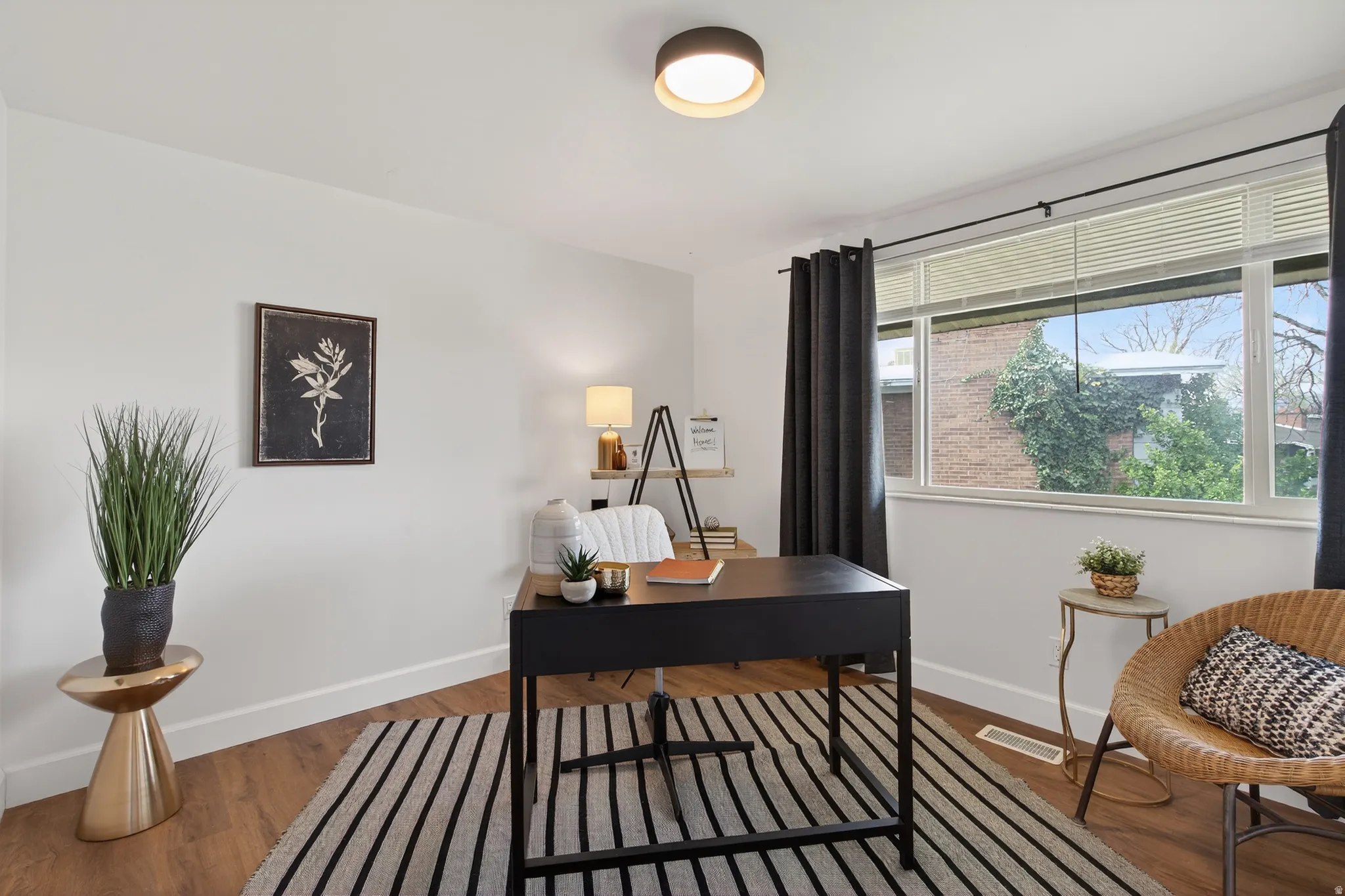 Home office featuring baseboards and wood finished floors