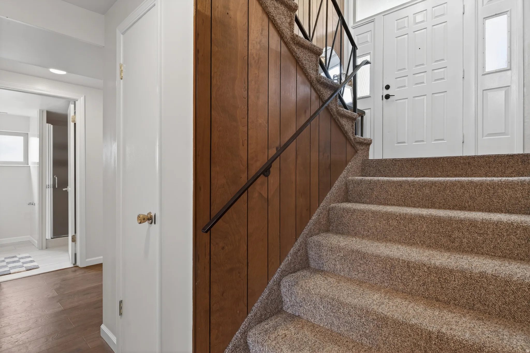 Stairway featuring carpeted floors and baseboards