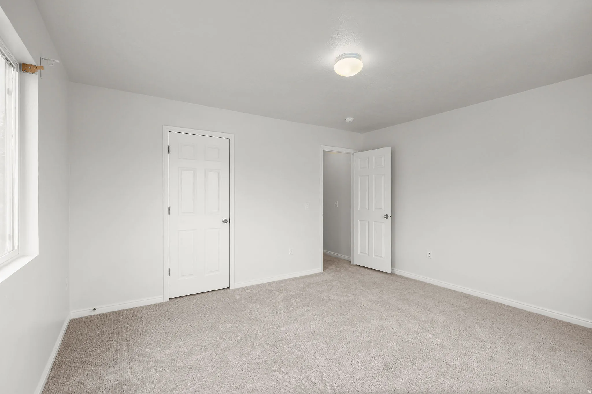 Unfurnished bedroom featuring carpet floors and baseboards