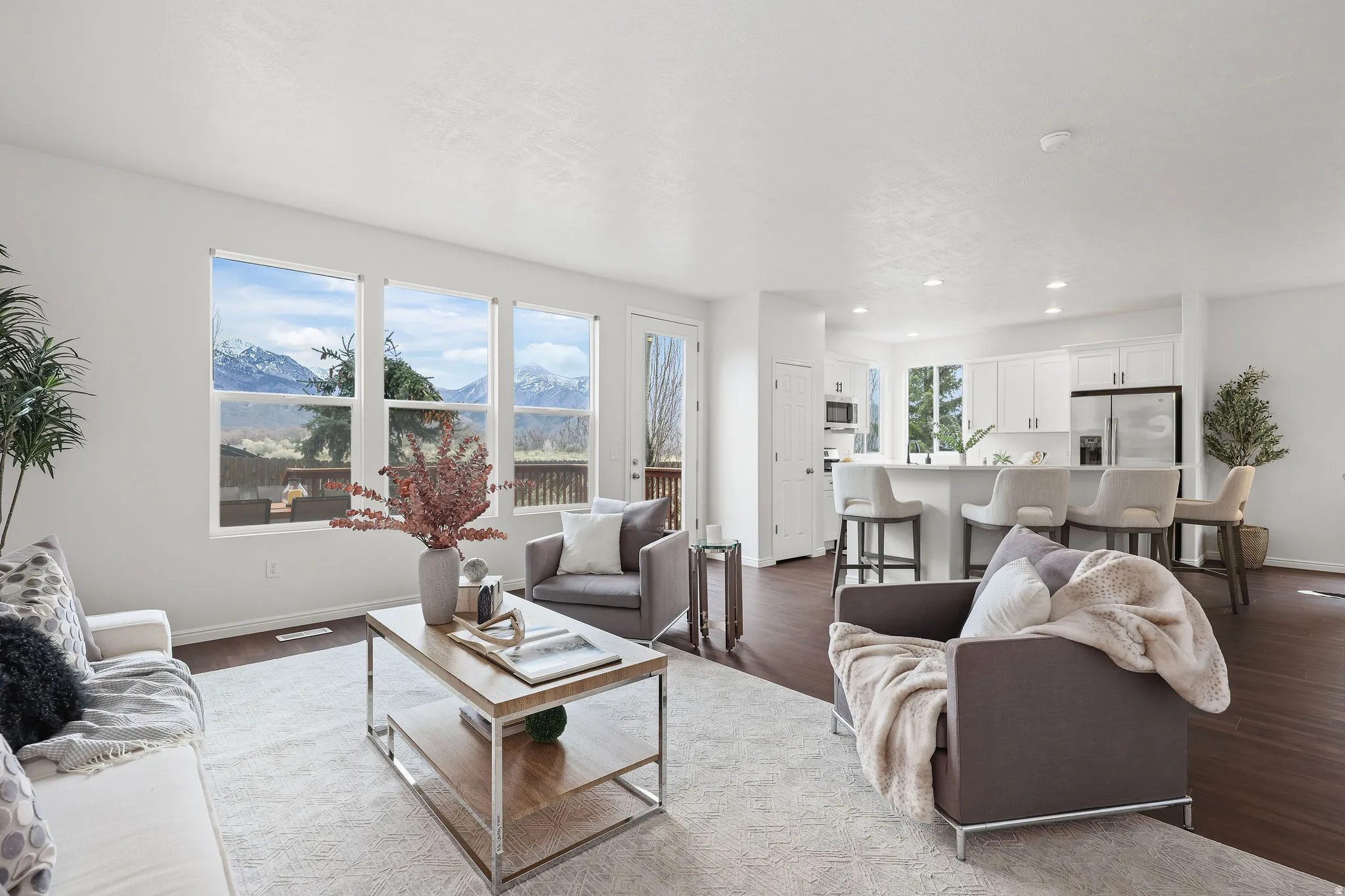 Living area with a mountain view, dark wood-type flooring, and recessed lighting