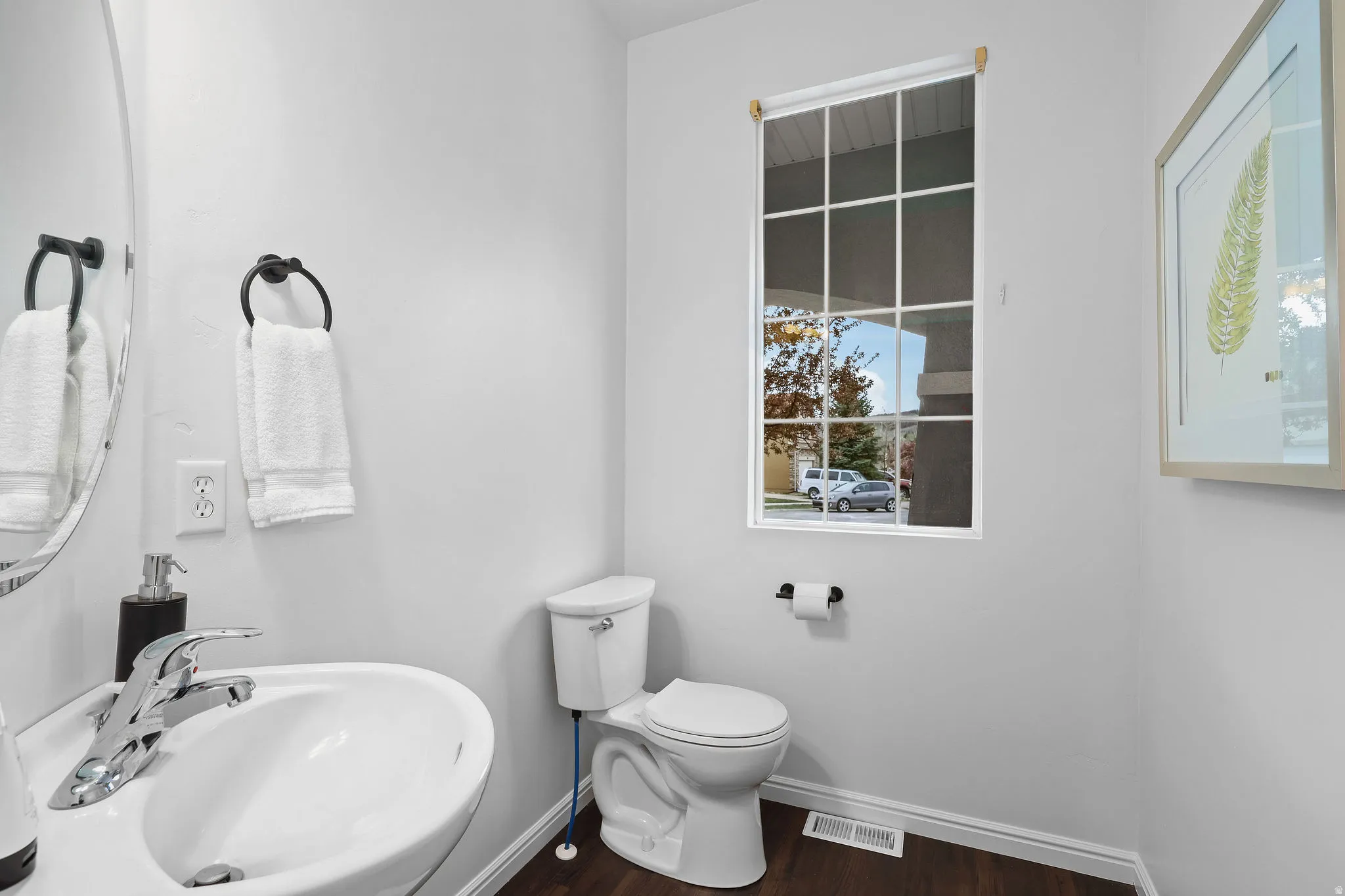 Bathroom with toilet and dark wood-style floors