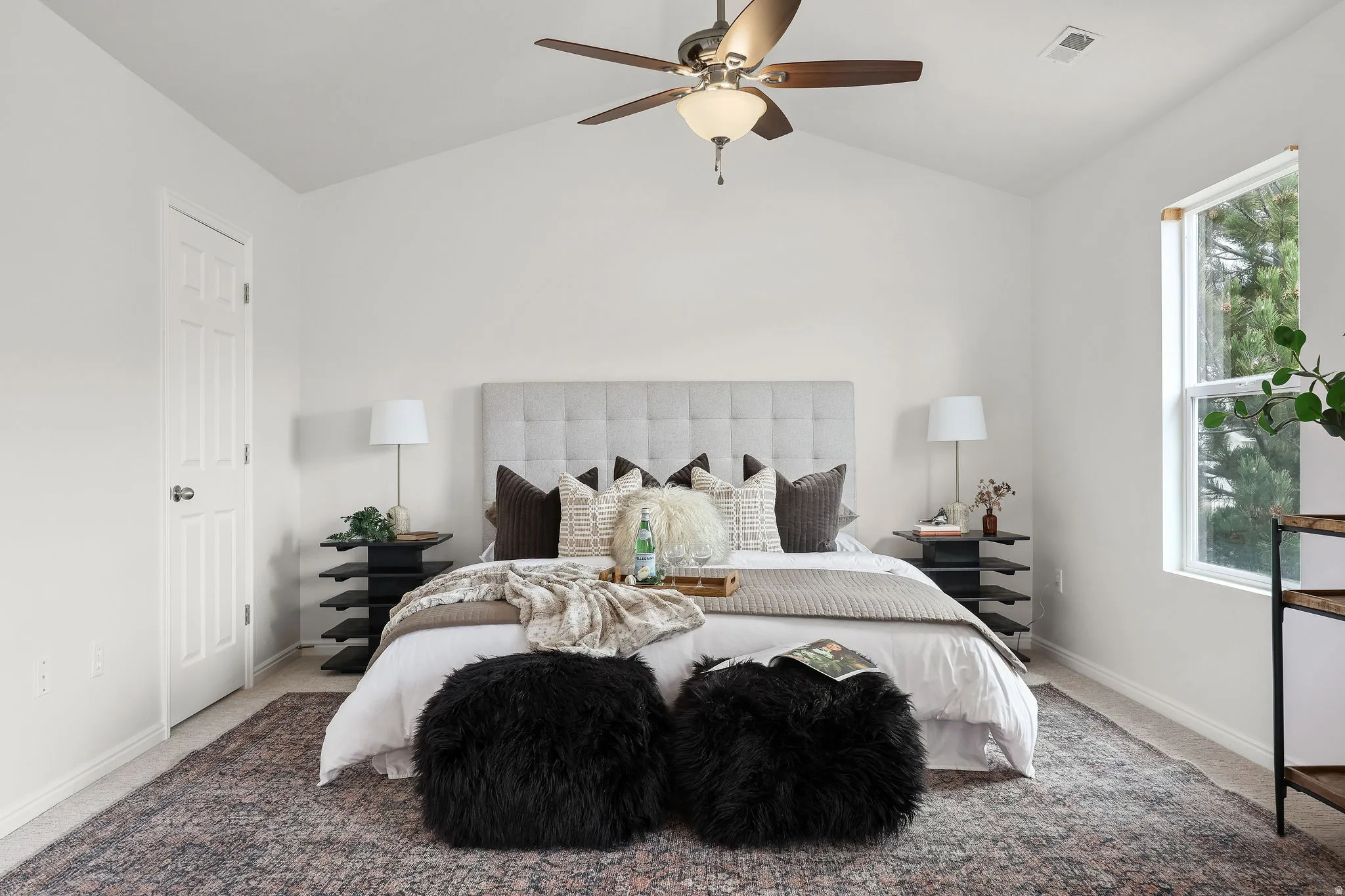 Bedroom featuring carpet floors, lofted ceiling, and a ceiling fan