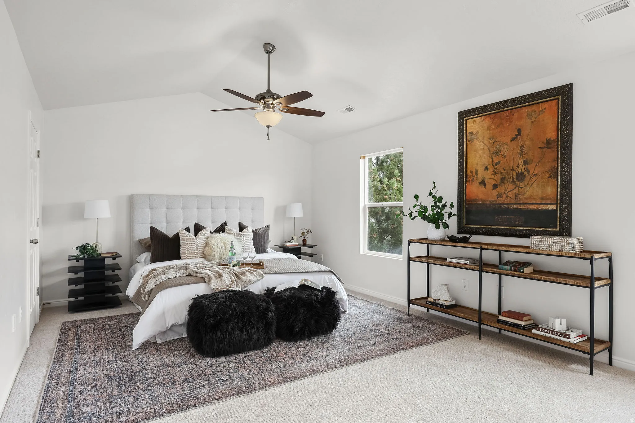 Carpeted bedroom featuring a ceiling fan and baseboards