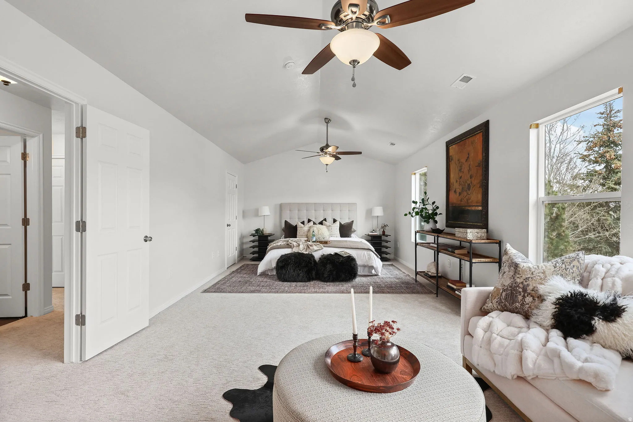 Bedroom featuring carpet, vaulted ceiling, and ceiling fan
