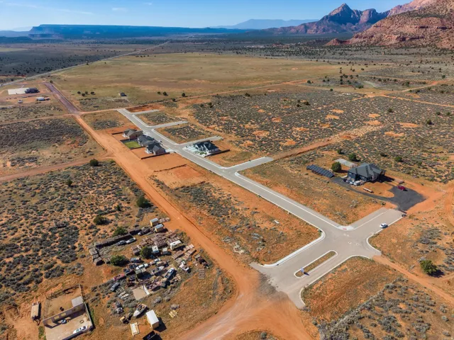 Aerial view of sparsely populated area with a desert landscape and a mountainous background