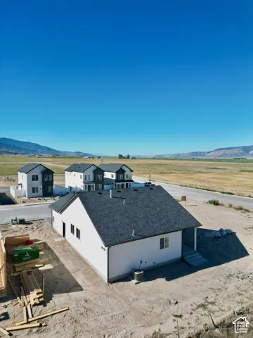 Newly constructed single-story residence featuring a dark shingle roof and a clean white exterior