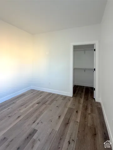 Light wood-finish flooring with white baseboards