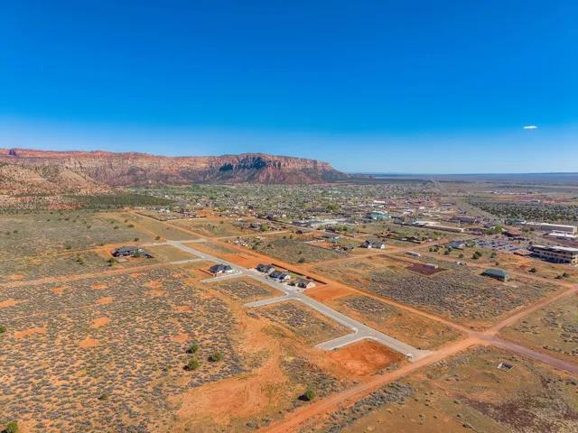 Aerial view of sparsely populated area with a mountain backdrop and a desert landscape