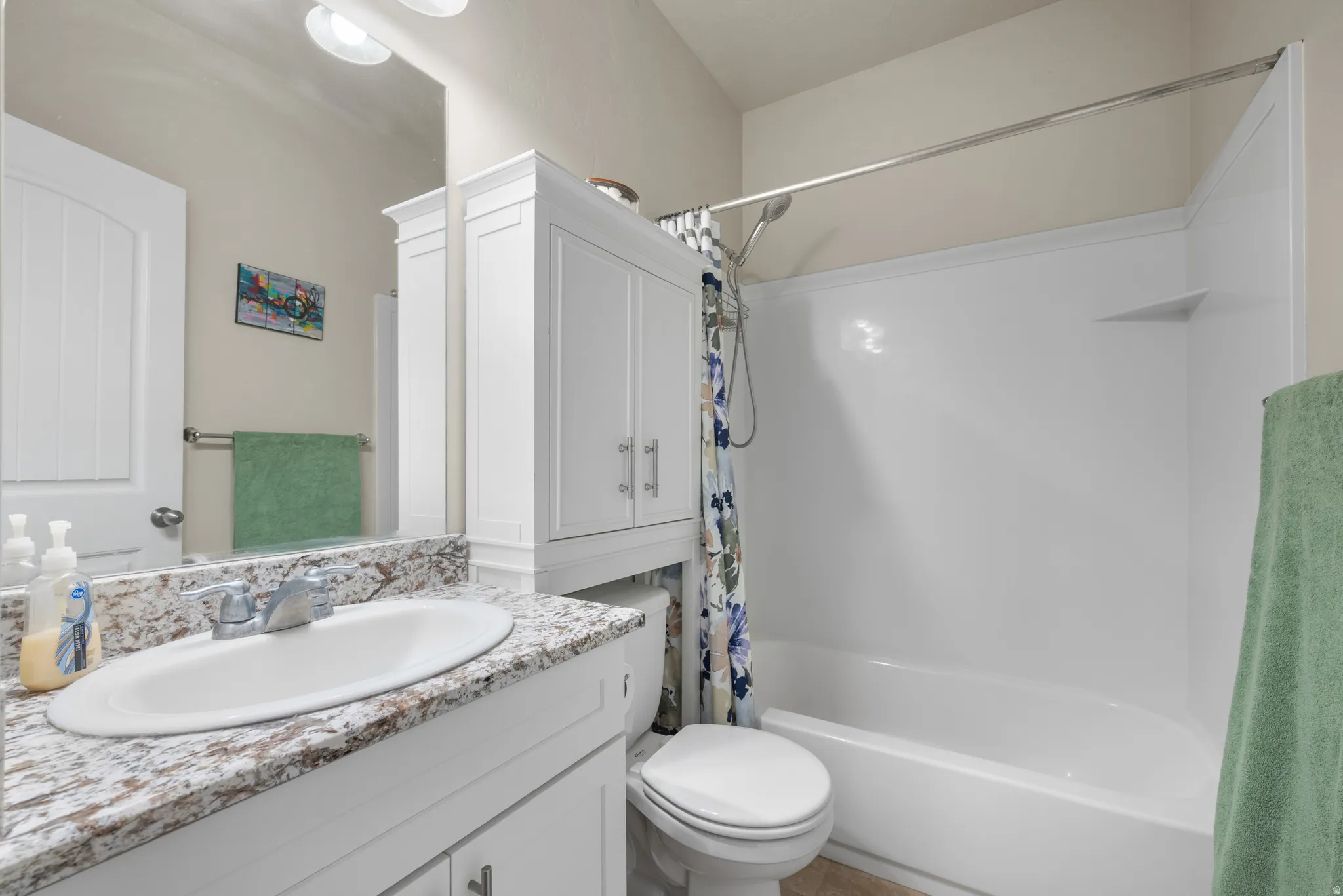 Full bath featuring vanity and shower / bathtub combination with curtain