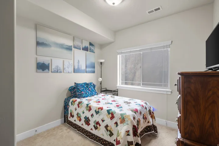 Carpeted bedroom featuring baseboards