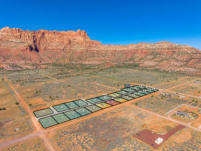 Aerial view of sparsely populated area with a desert landscape and a mountain backdrop