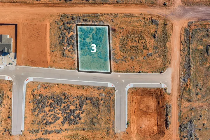 Aerial view of property and surrounding area featuring a desert landscape and property parcel outlined