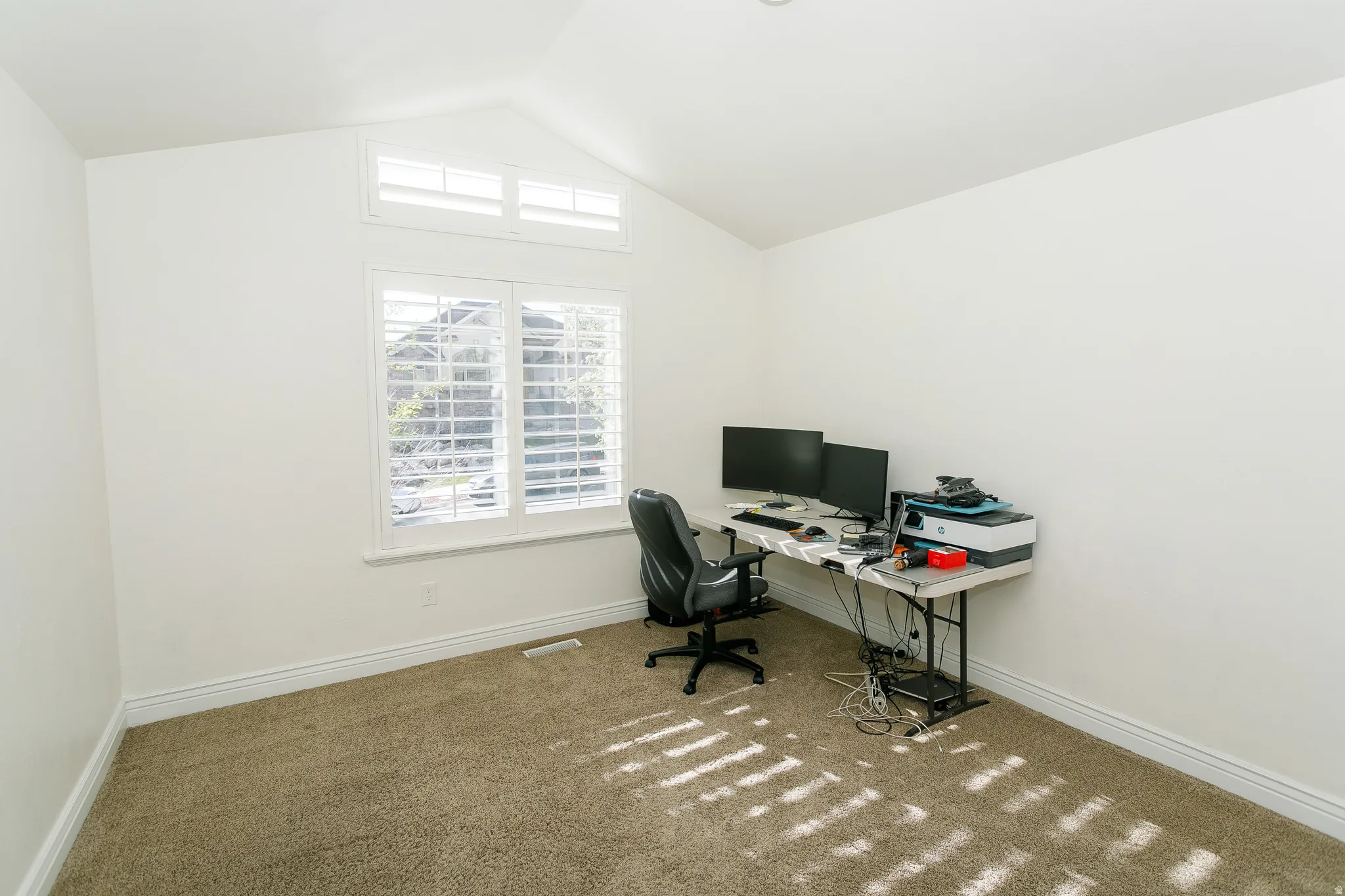 Office space featuring carpet flooring and baseboards