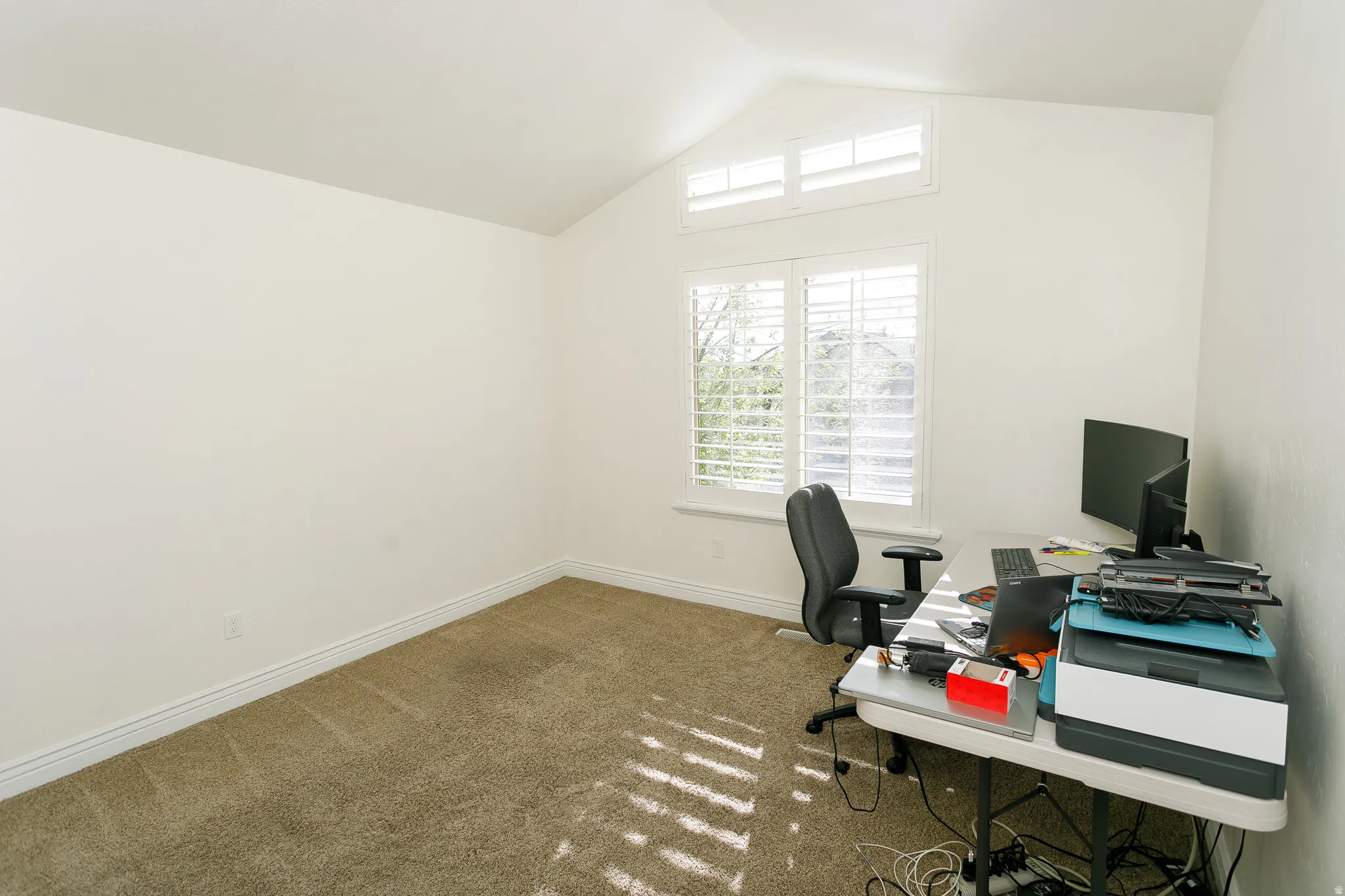 Office area featuring carpet floors and baseboards