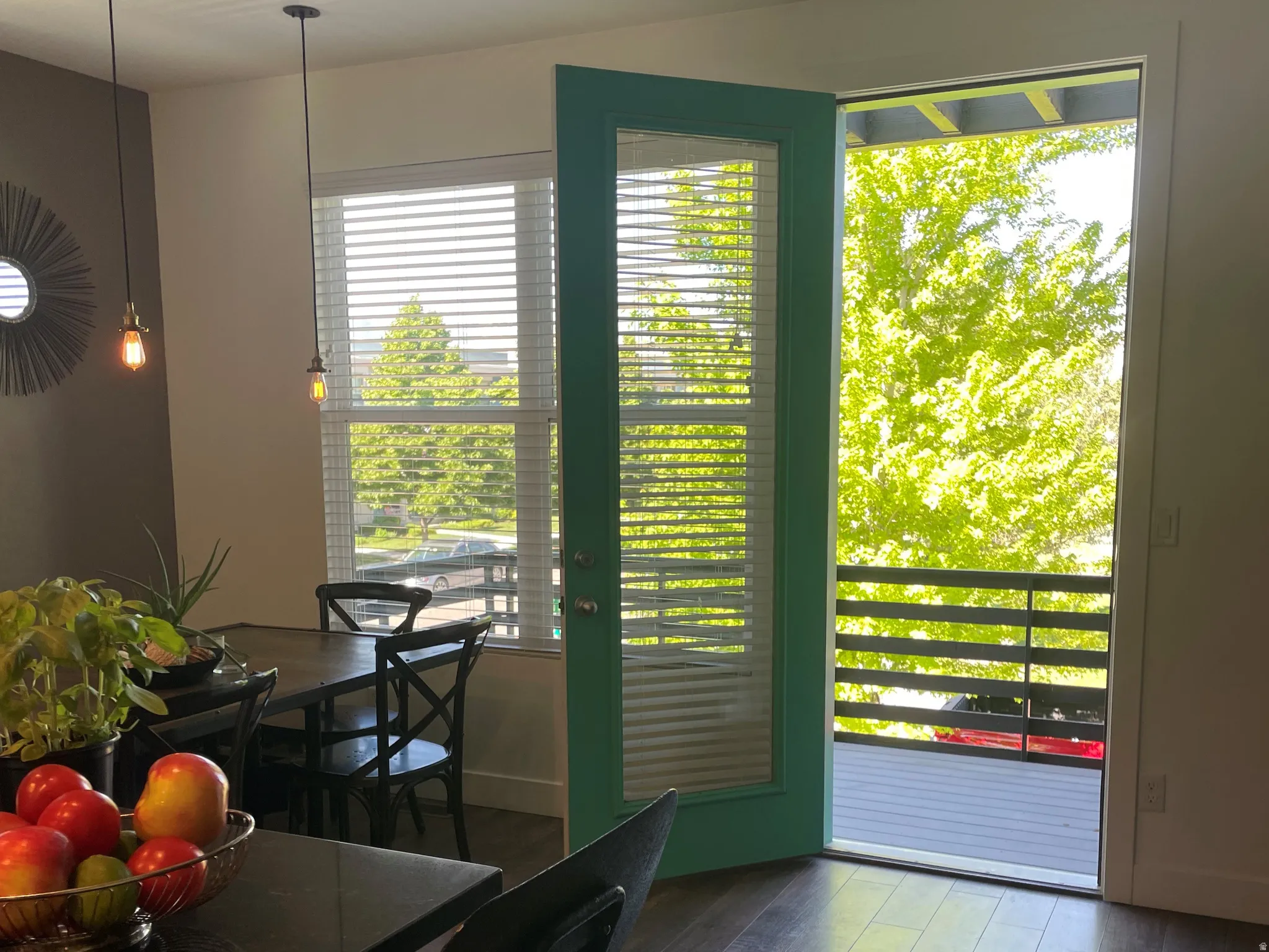 Dining room table with built in bench of restored wood accents (seats 6). Windows & natural light! Views of the park off the balcony. A perfect place for grilling!