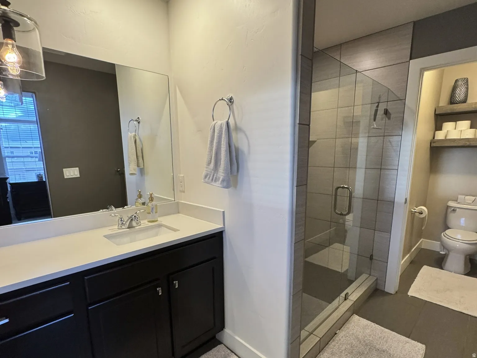 Main bathroom with vanity, walk-in shower & walk-in closet