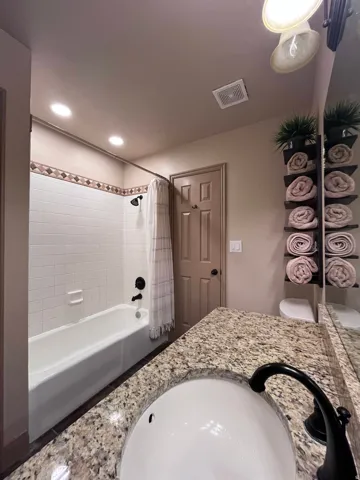 Full bathroom featuring vanity and shower / tub combo