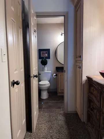 Half bathroom with vanity and toilet