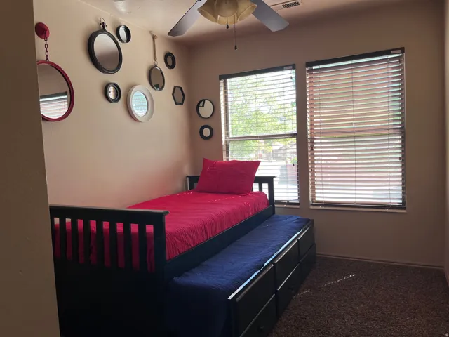 Bedroom featuring carpet and ceiling fan