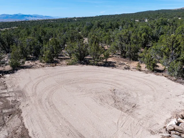 Cleared and level building site surrounded by mature trees