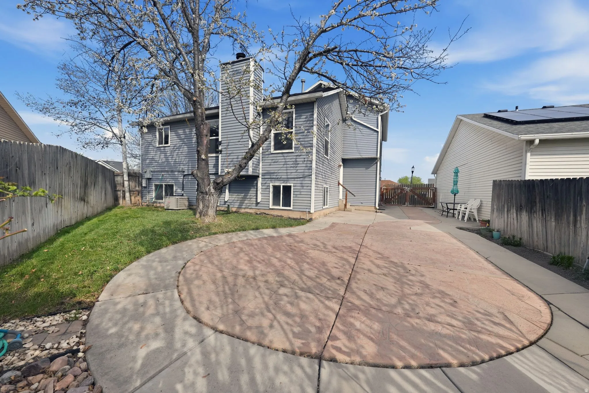 Rear view of property with a chimney and a fenced backyard