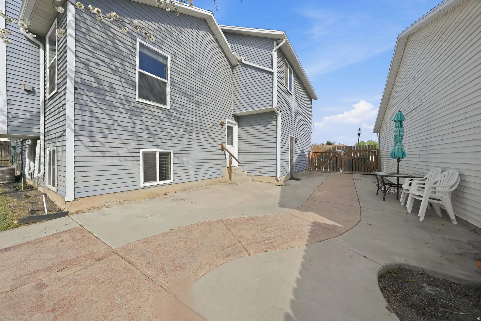 Rear view of property with a patio area and a gate