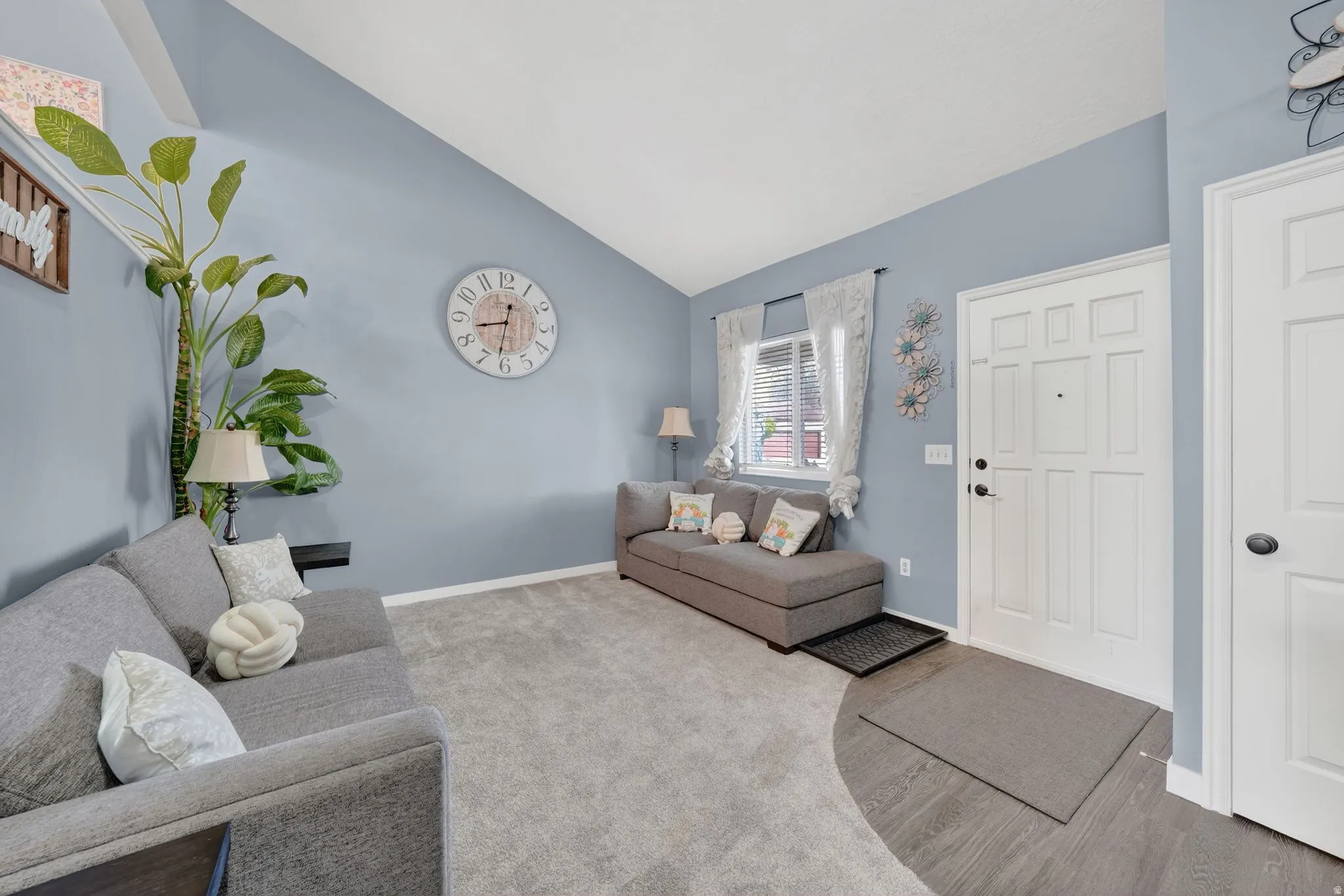 Living area featuring lofted ceiling and wood finished floors