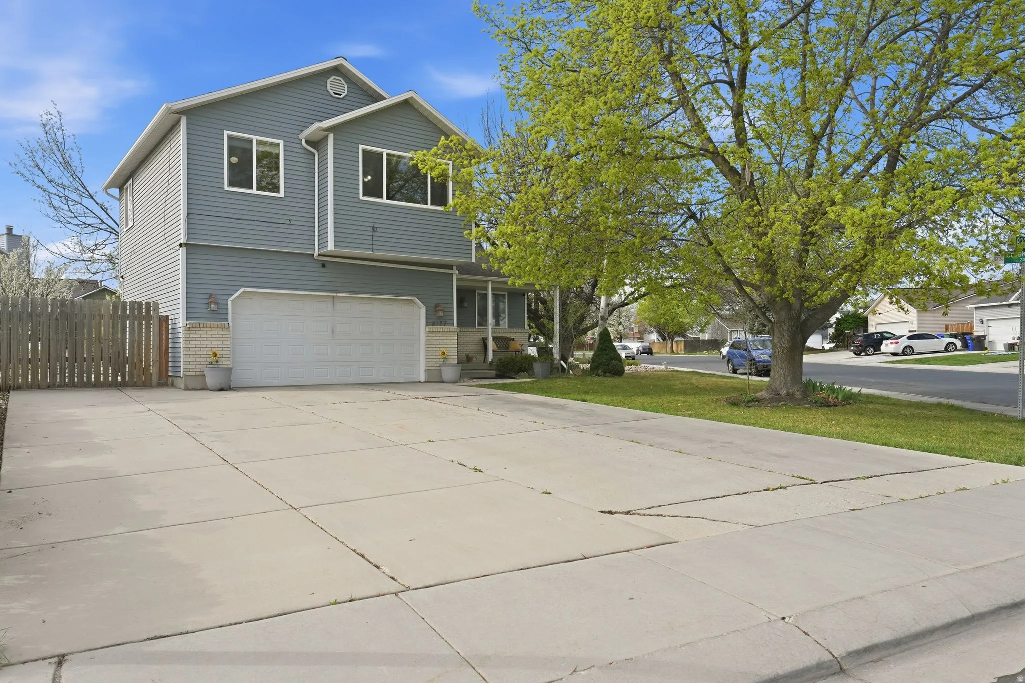 View of front of property with an attached garage, driveway, and a residential view