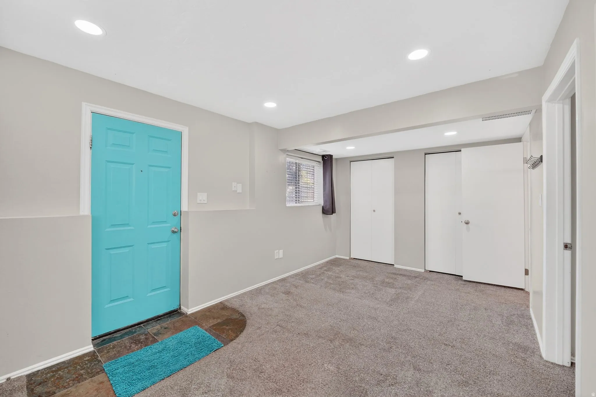 Foyer with carpet floors and recessed lighting