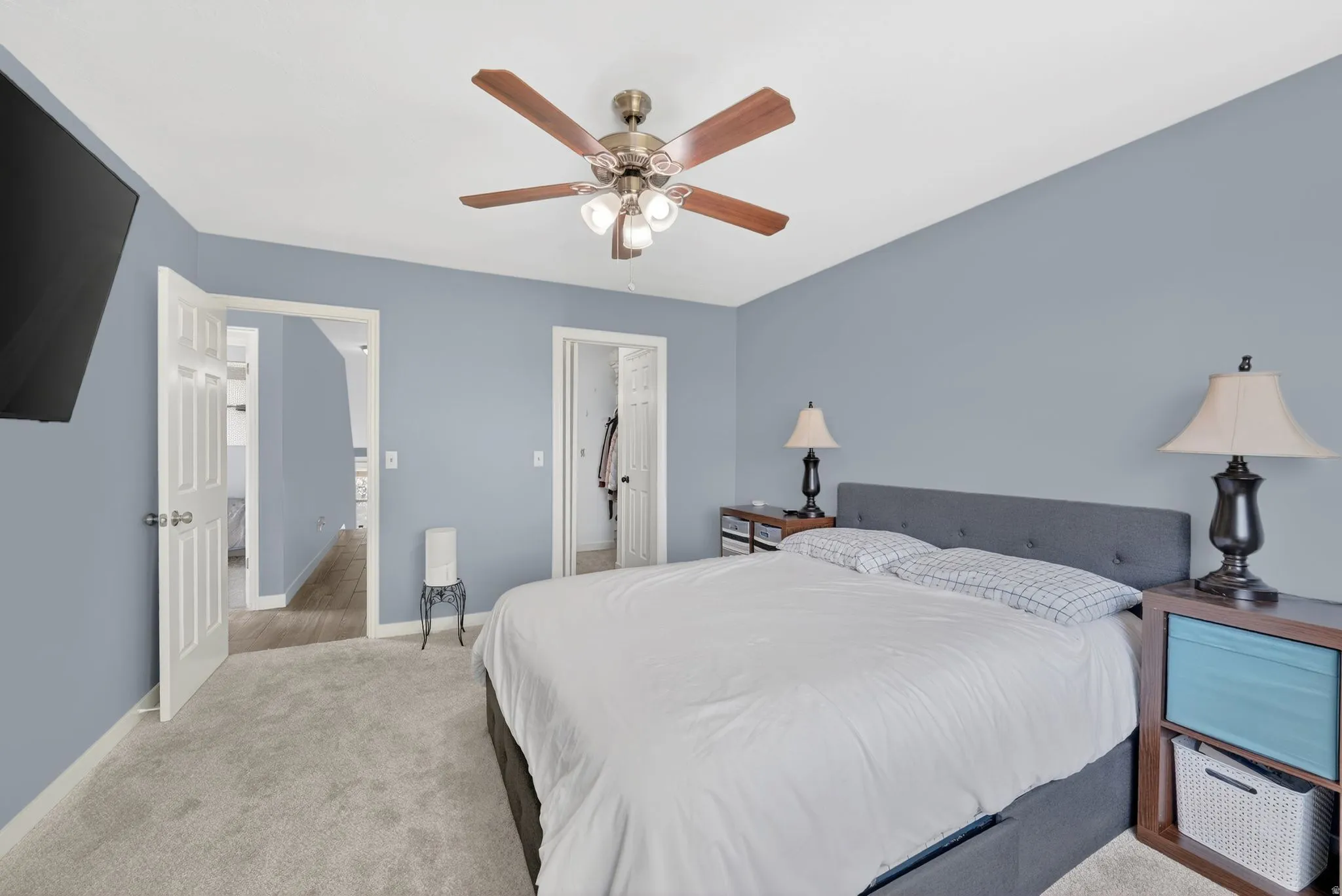 Carpeted bedroom with baseboards and a ceiling fan