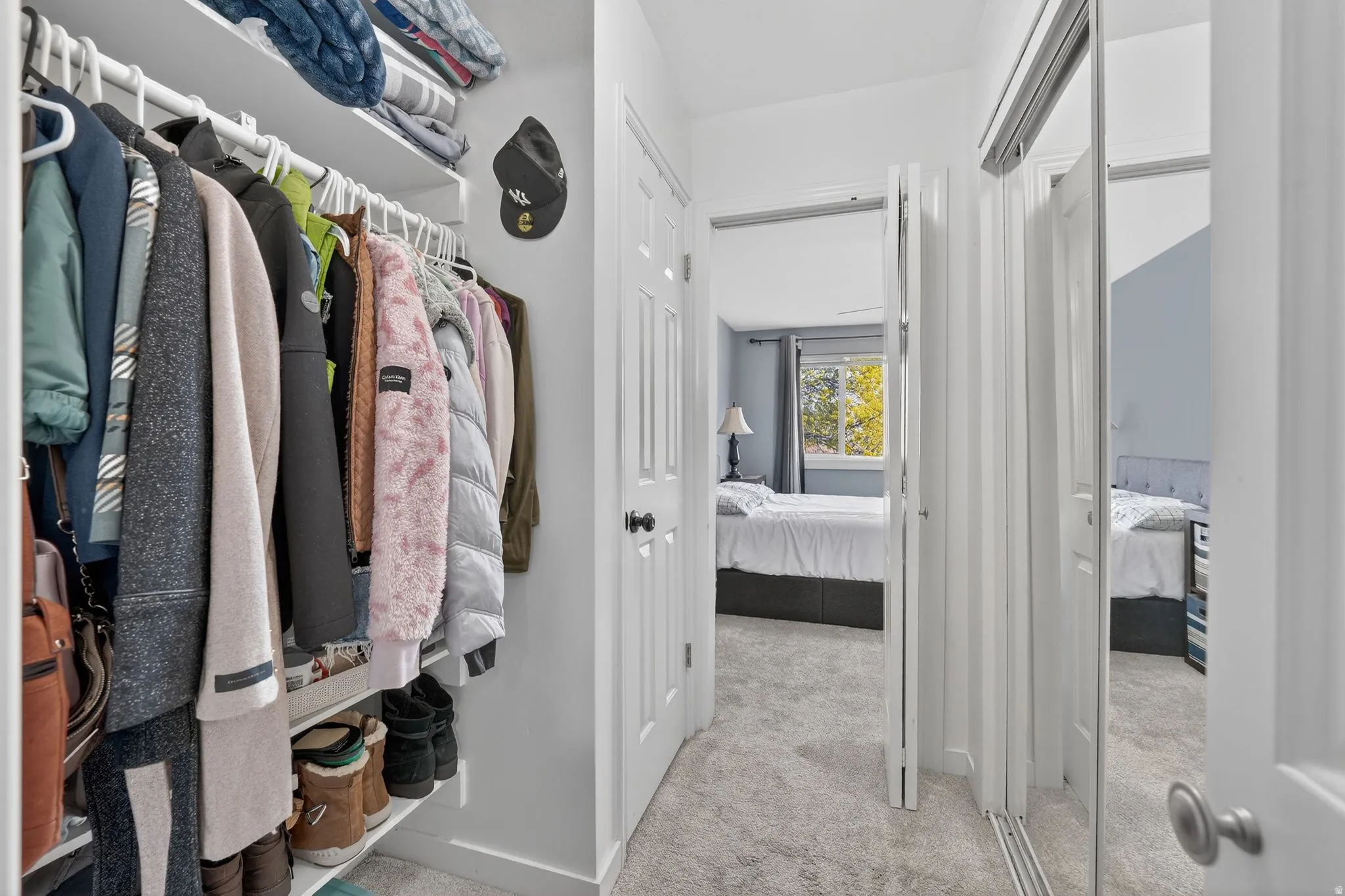 Walk in closet with light carpet