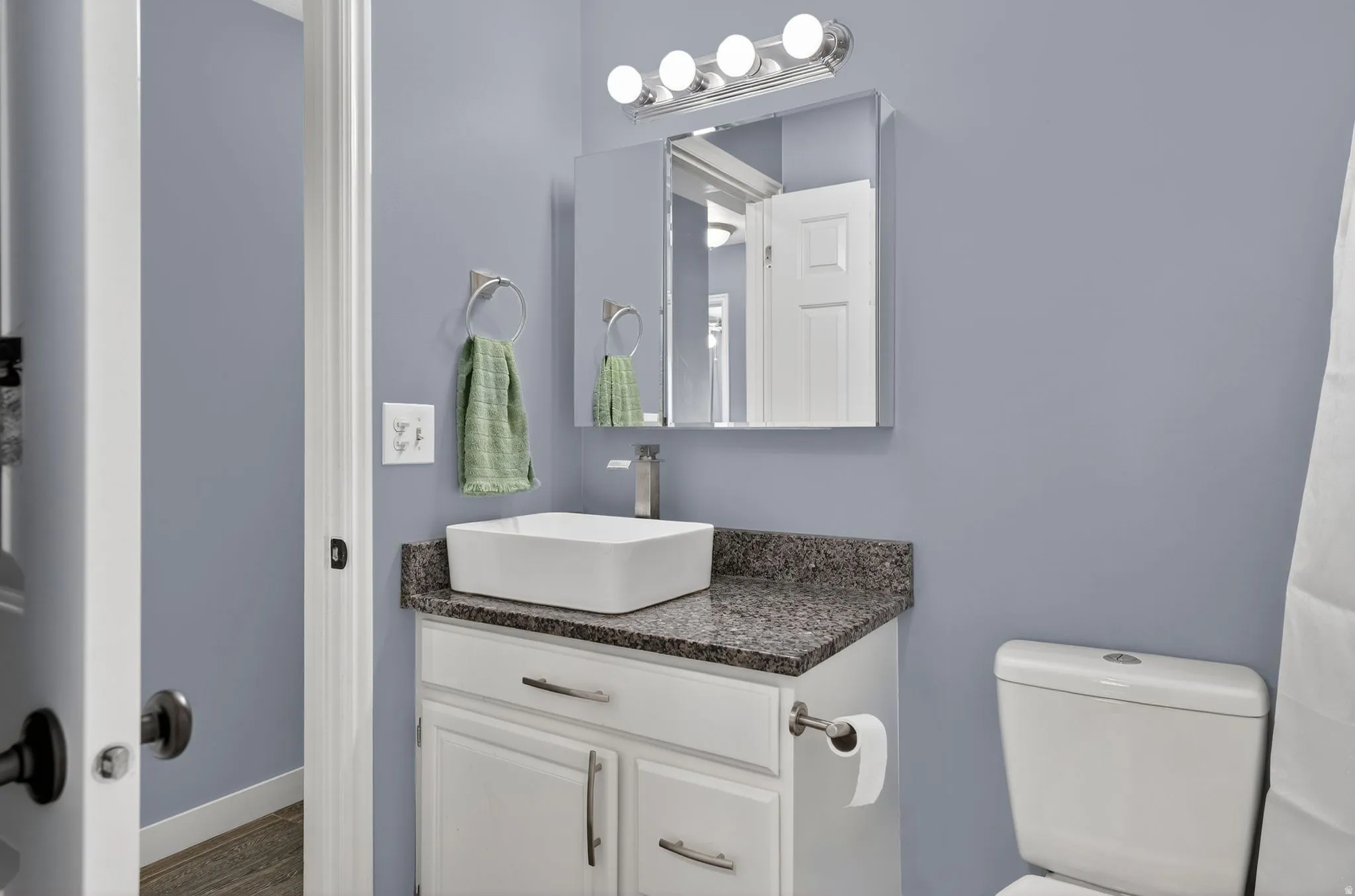 Half bath with vanity and toilet