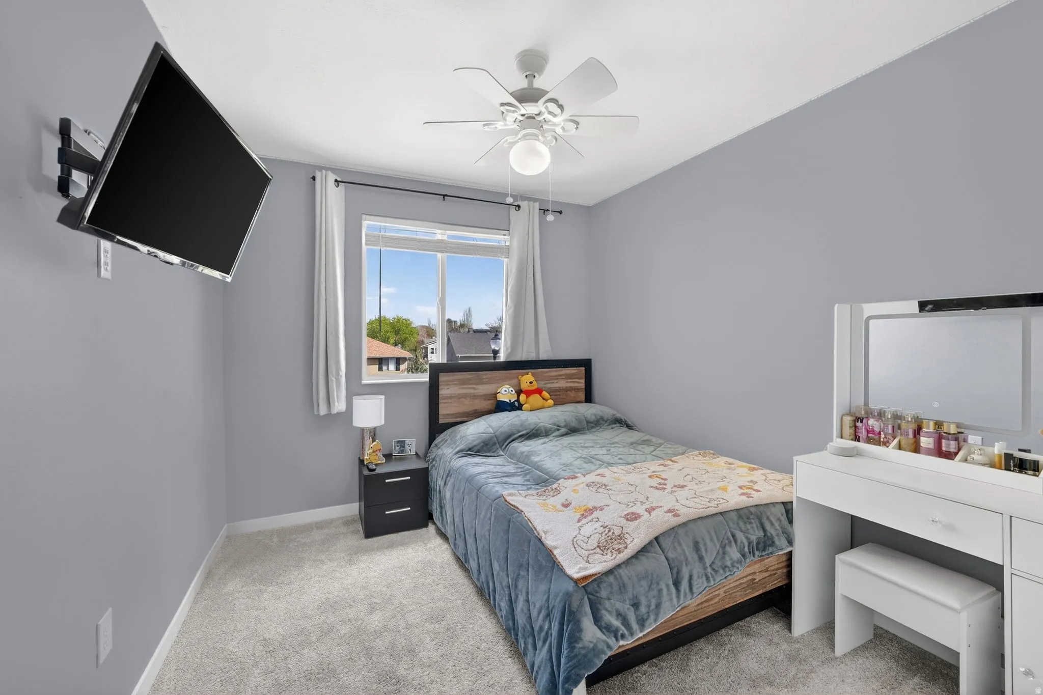 Bedroom featuring light carpet and a ceiling fan