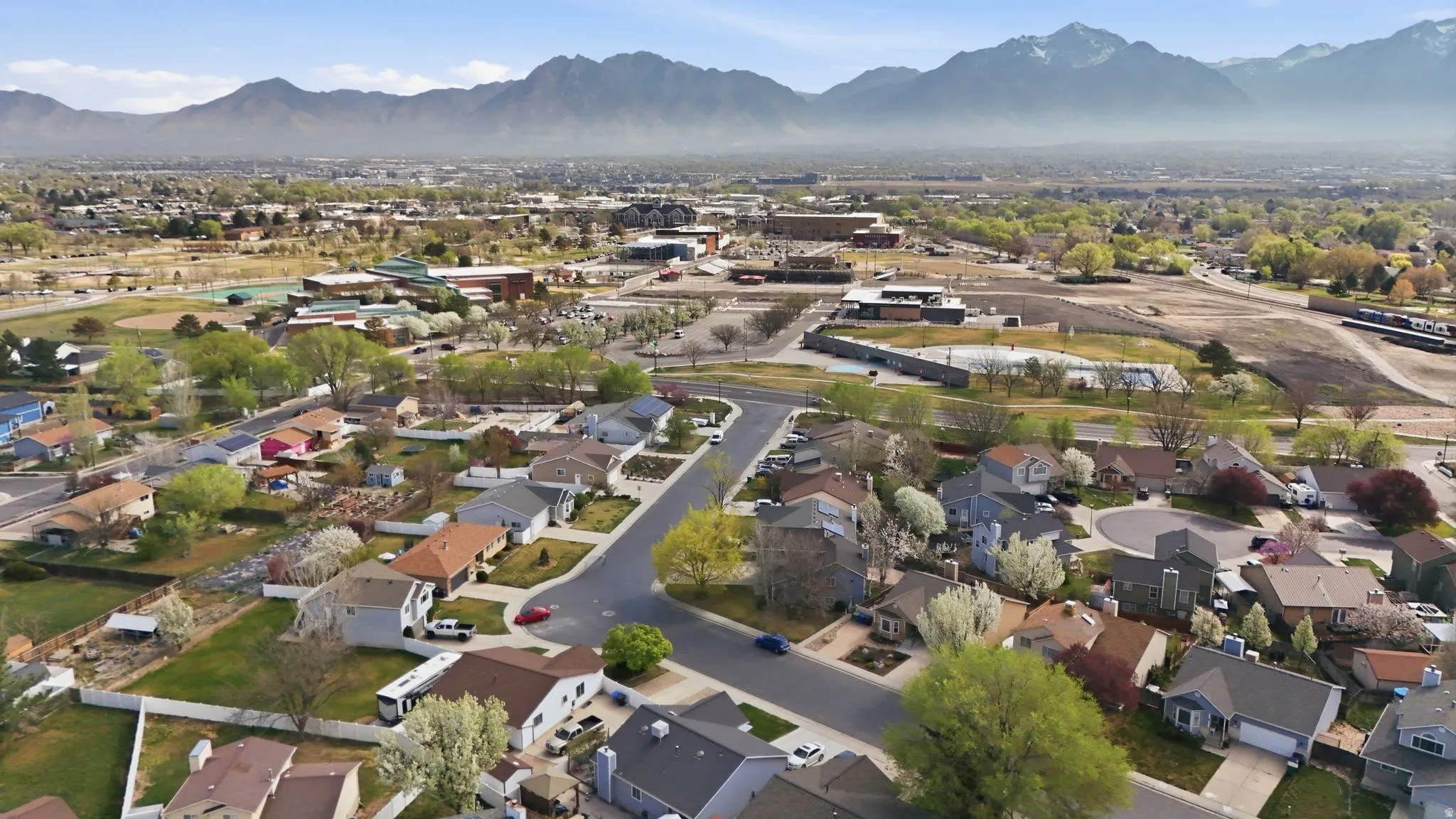 Aerial perspective of suburban area with a mountain backdrop