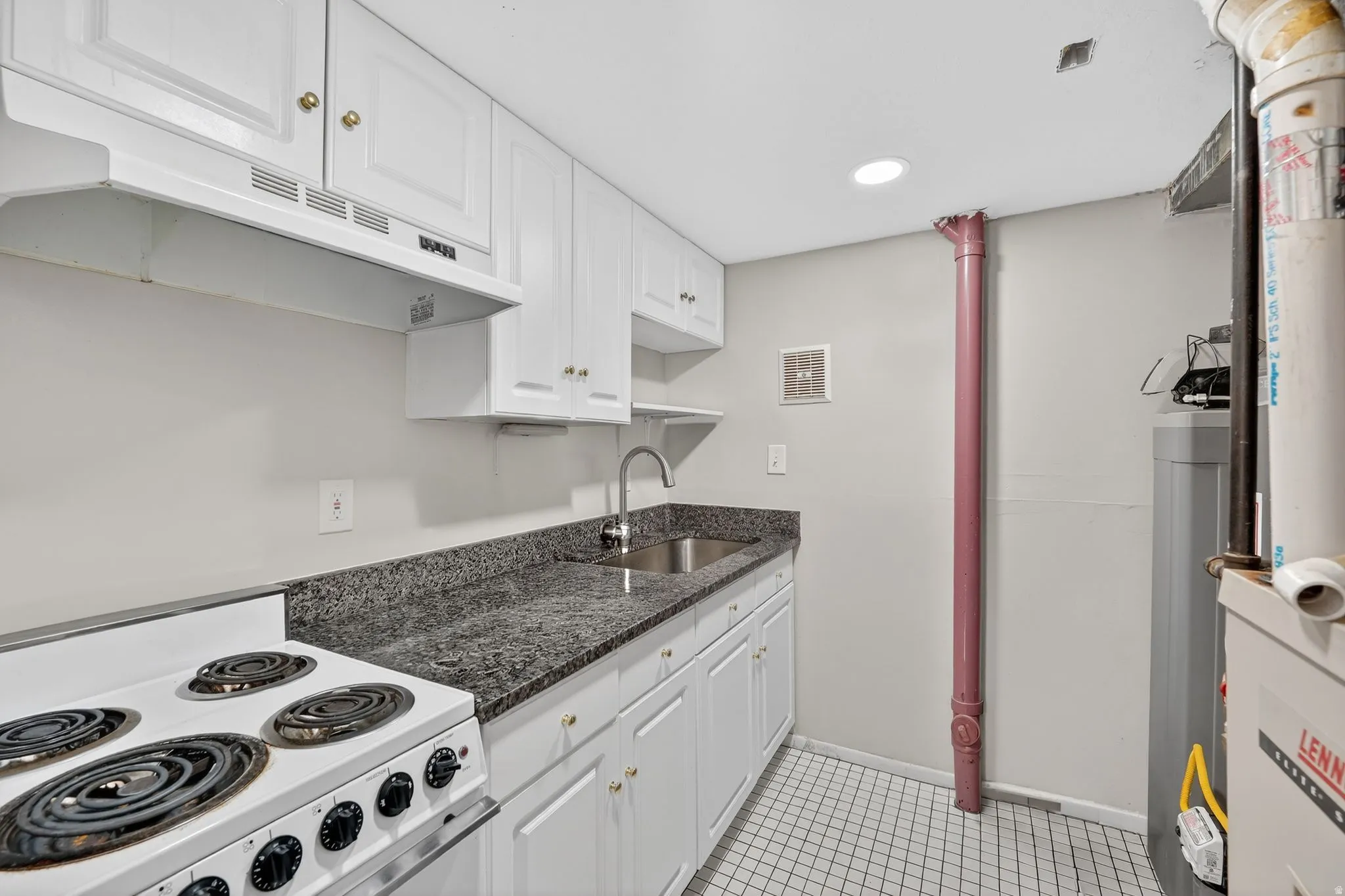 Kitchen with white cabinets, white range with electric cooktop, recessed lighting, dark stone counters, and open shelves