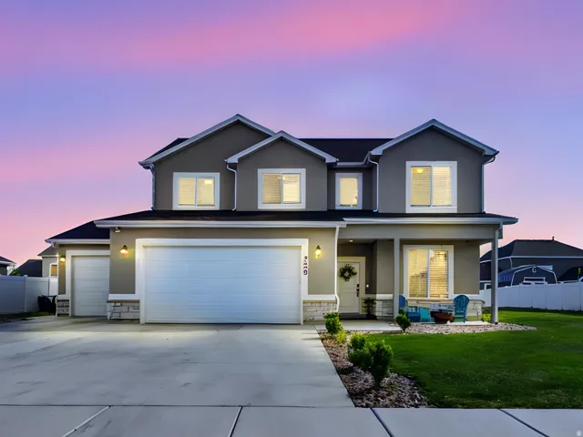 Contemporary two-story residence featuring a neutral-toned exterior with white trim