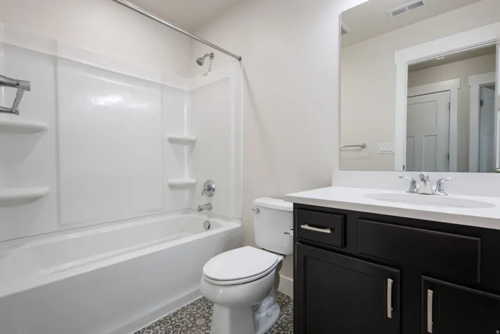 Bathroom featuring vanity and shower / tub combination