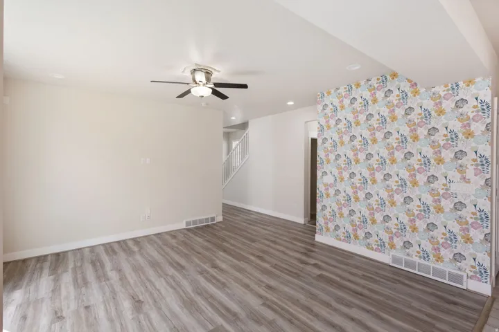Spare room with a ceiling fan, light wood finished floors, and recessed lighting