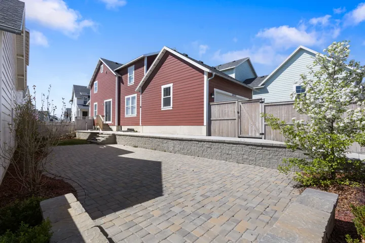 View of home's exterior with a gate, a fenced backyard, and a patio area