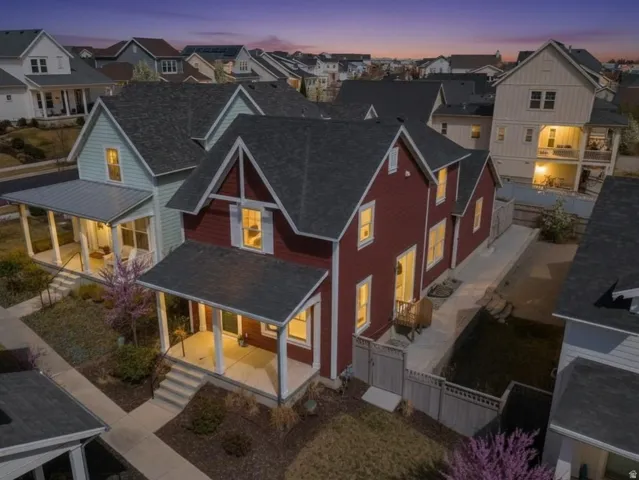 Back of house featuring roof with shingles, a porch, and a residential view