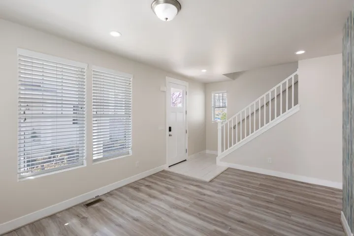 Entryway with light wood finished floors and recessed lighting
