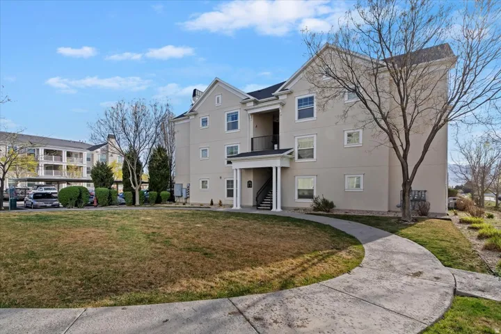 View of front of house featuring a front yard and stucco siding