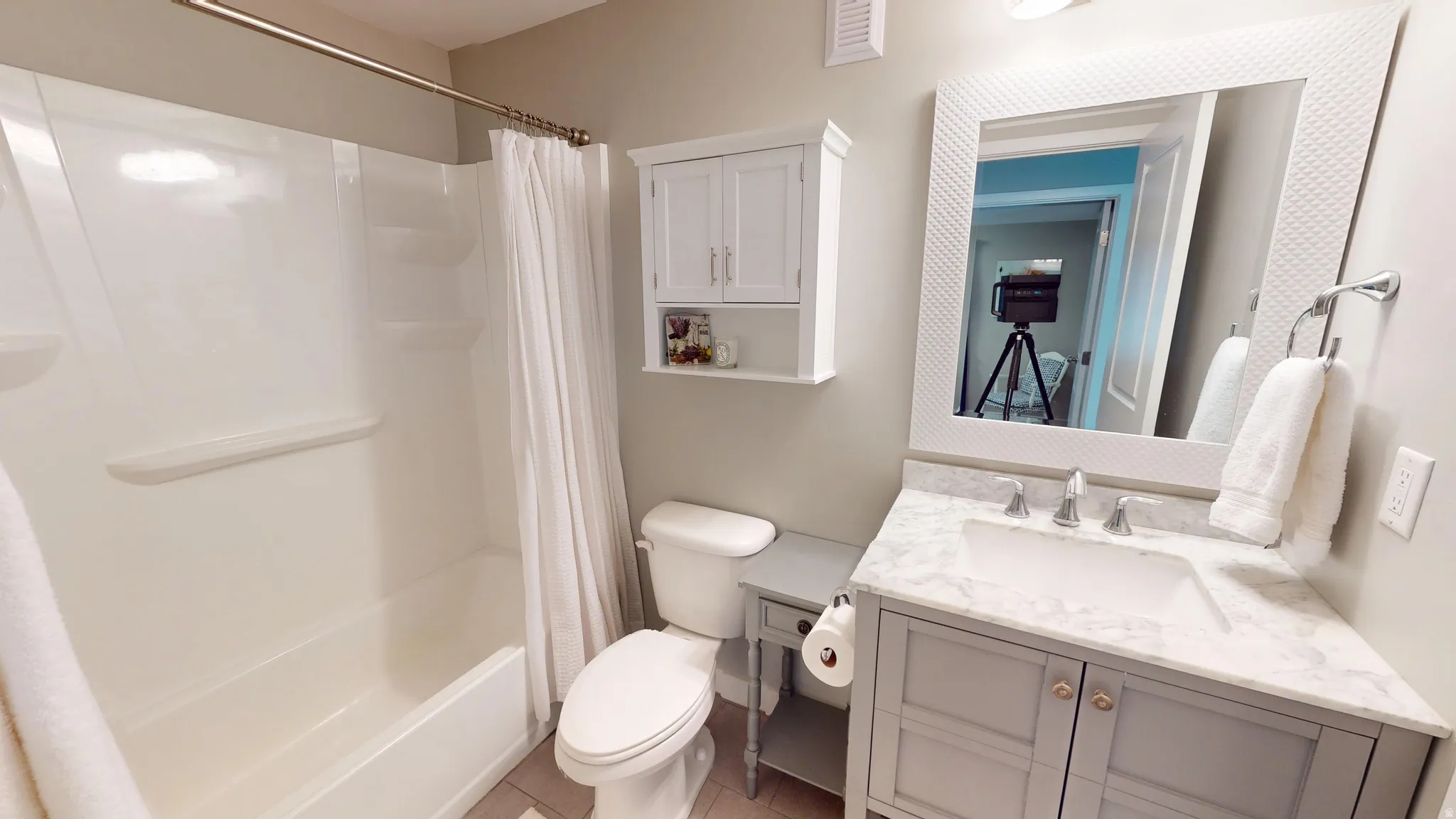 Lower level full bathroom featuring vanity, shower / tub combo