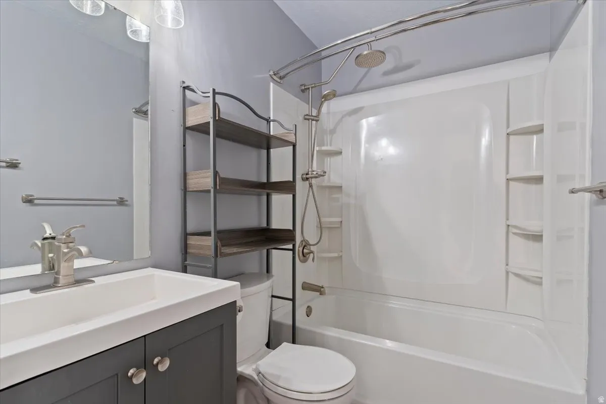 Bathroom with vanity and shower / tub combination