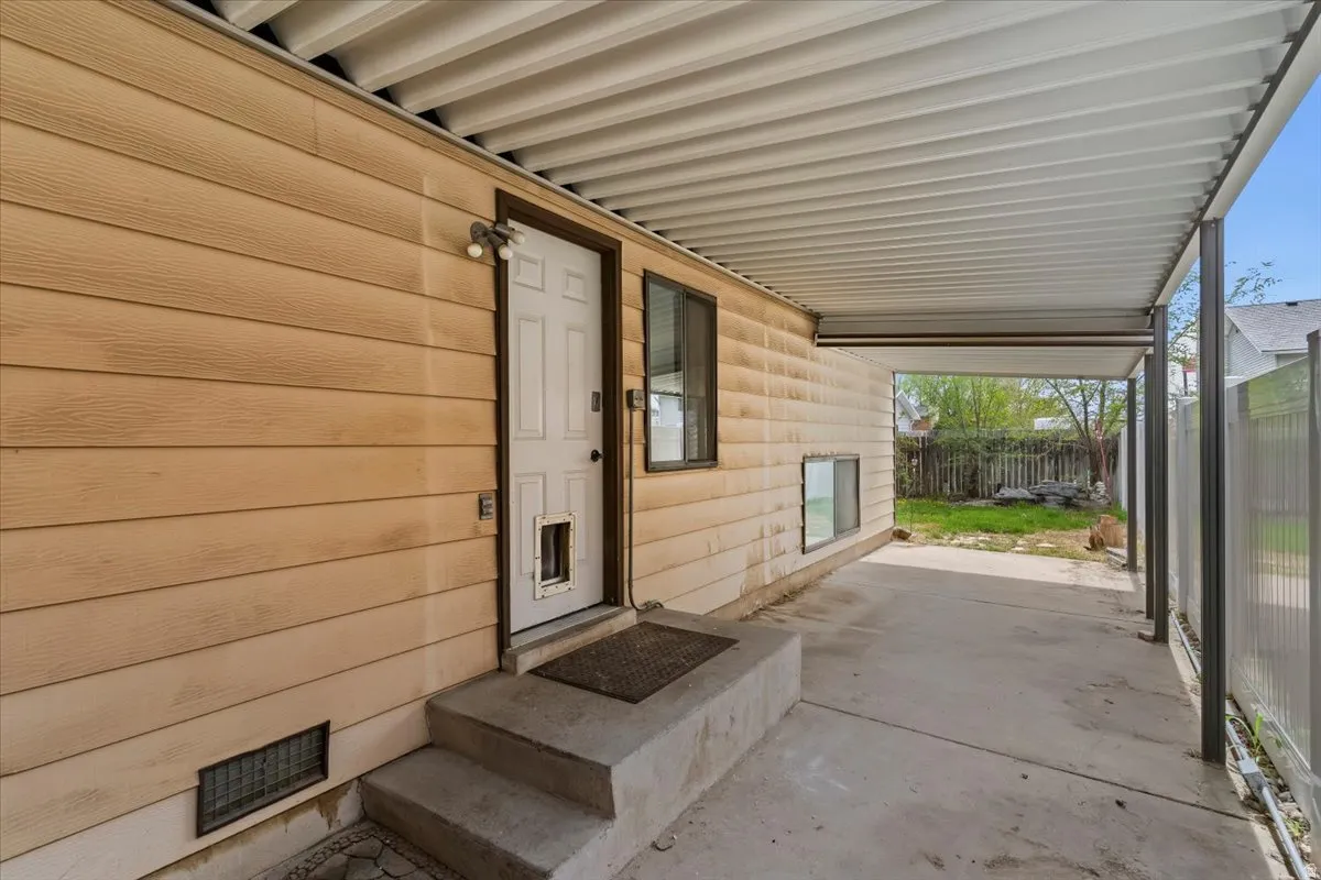 Entrance to property featuring covered porch