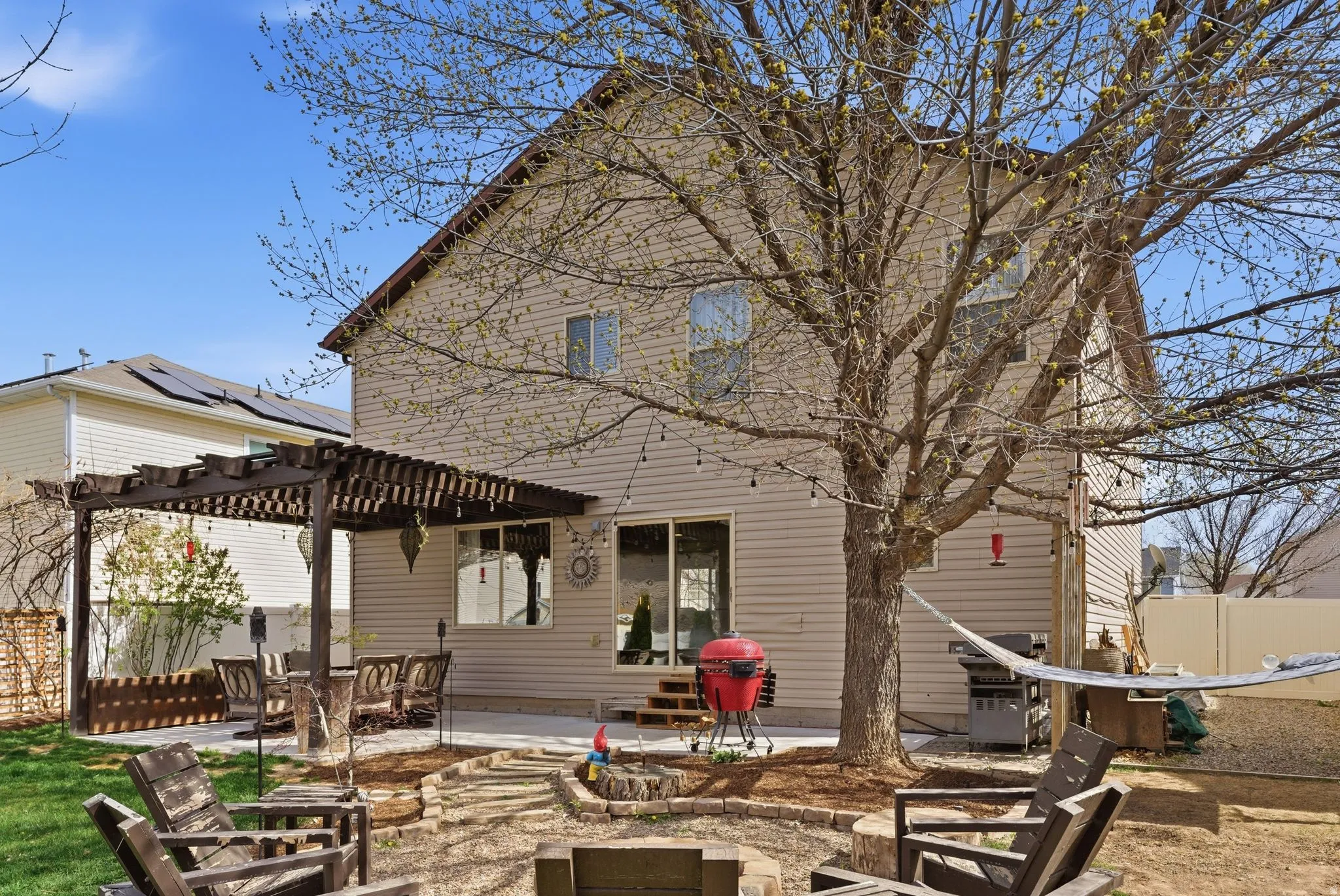 Rear view of house featuring a patio and a pergola