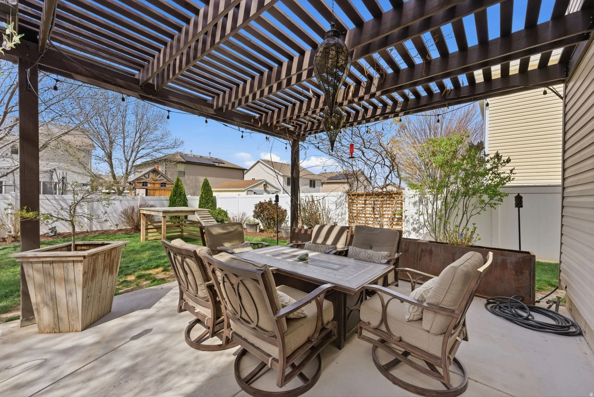 Fenced backyard with outdoor dining area, a patio, and a residential view