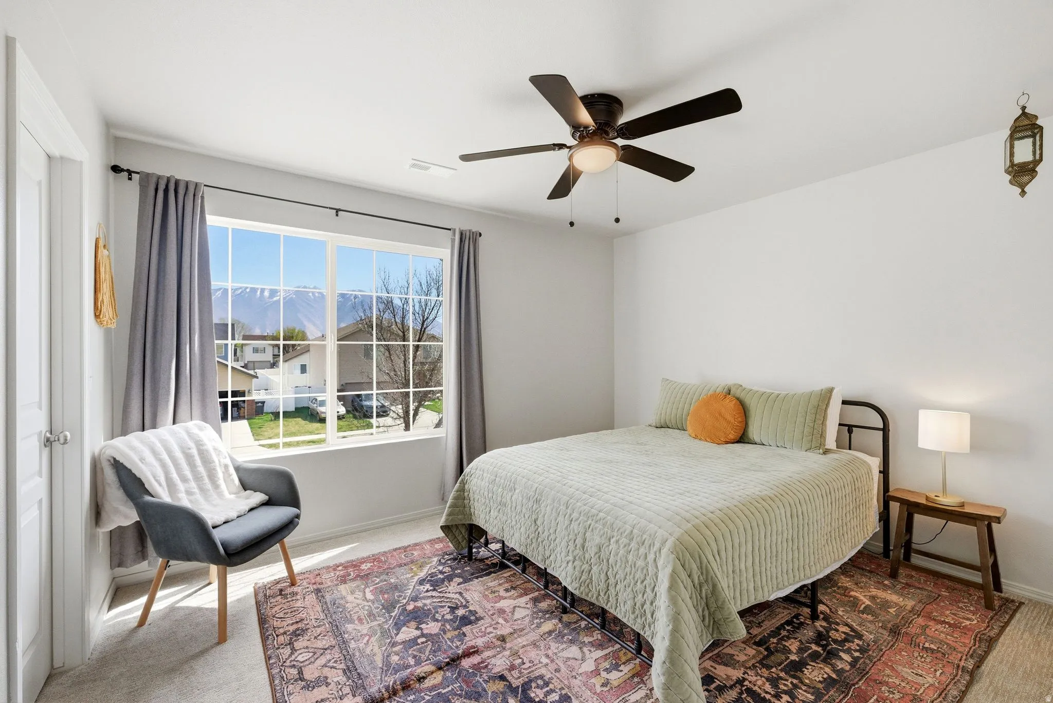 Bedroom featuring light colored carpet and ceiling fan